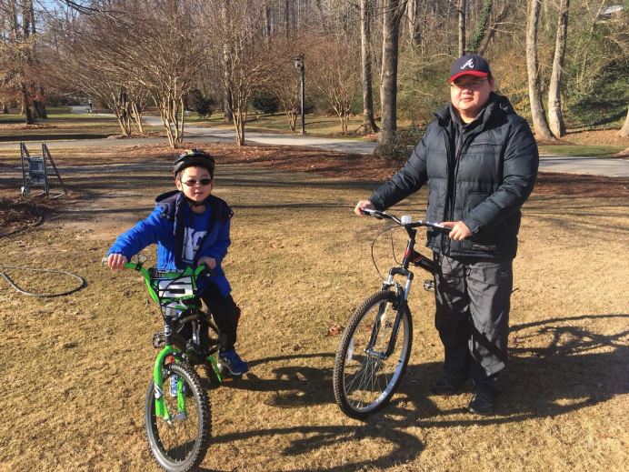 father with son biking to support k9